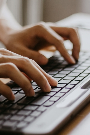 Closeup of an IT expert performing a disaster recovery process on computer keyboard