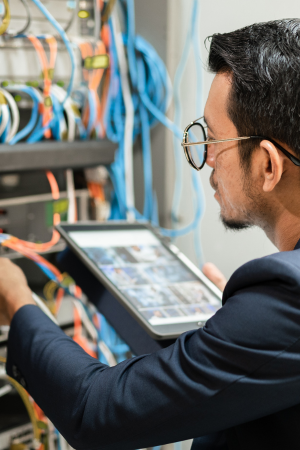 Man testing IT Infrastructure with a hand held computer