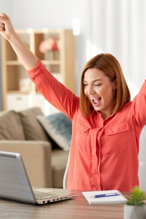 Happy Lady at Computer after seeing CybrSupport's pricing